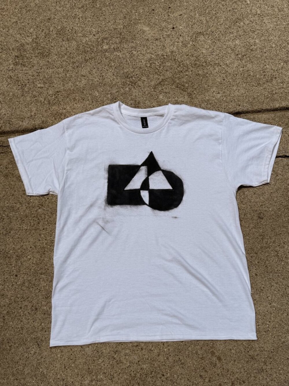 Spray painted design on a plain white shirt.